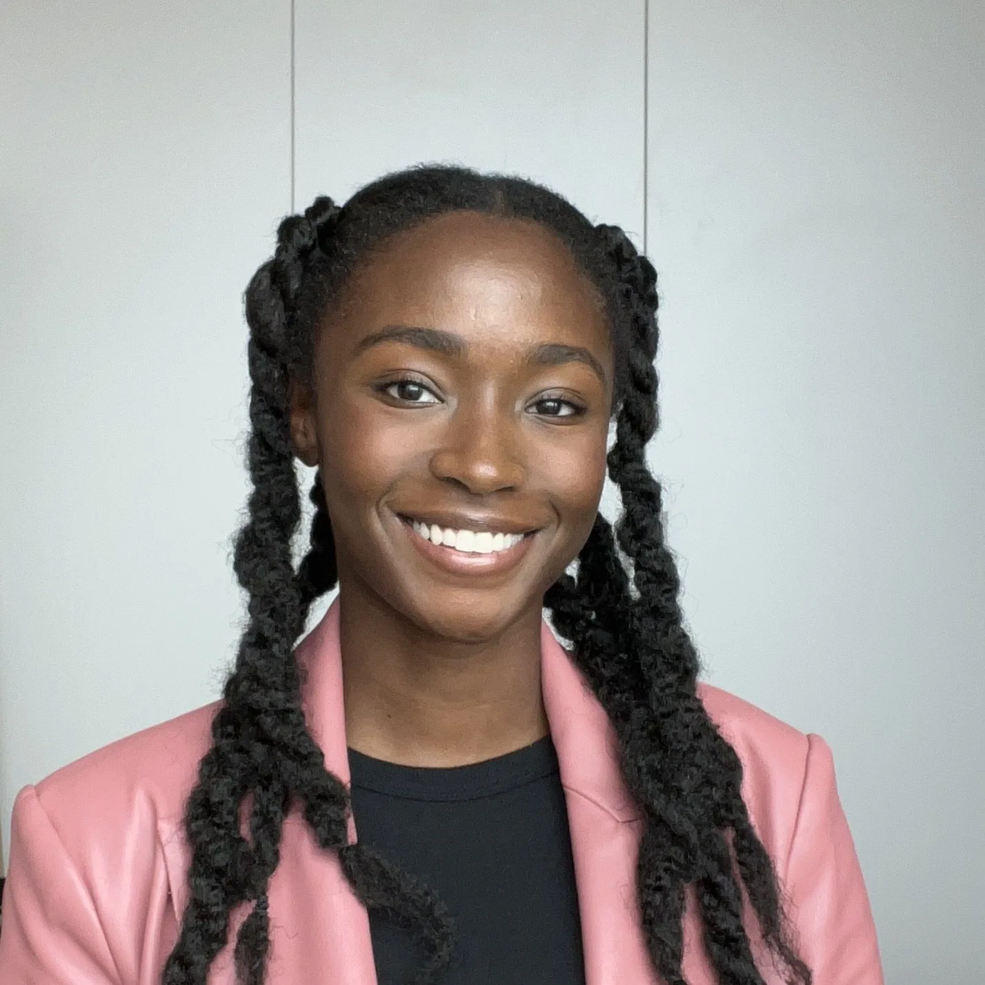 Professional headshot of Kia, featuring a confident and friendly smile.